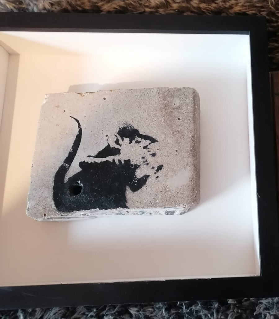 Banksy graffiti rat on a piece of masonry removed from Providence place in Brighton